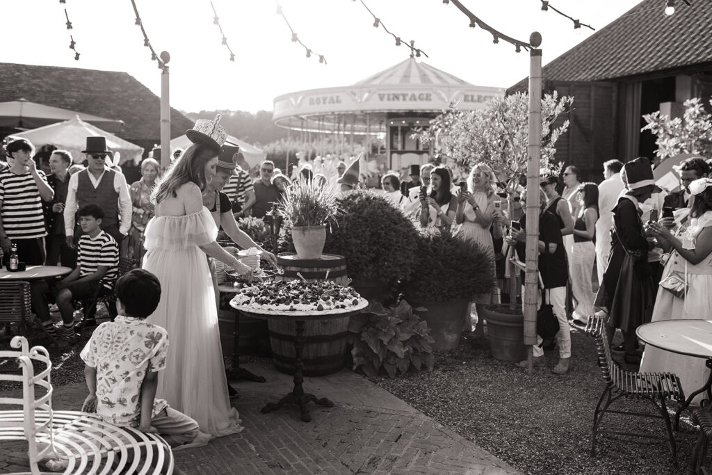 Cutting the giant pavlova in the barnyard at Preston Court Estate, Kent.
