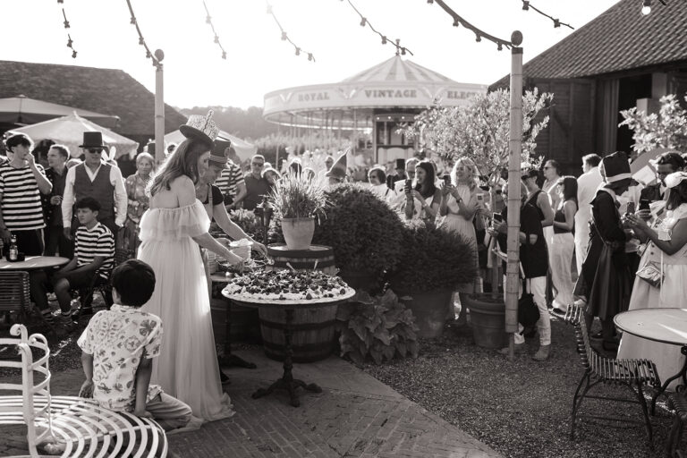 Cutting the giant pavlova in the barnyard at Preston Court Estate, Kent.